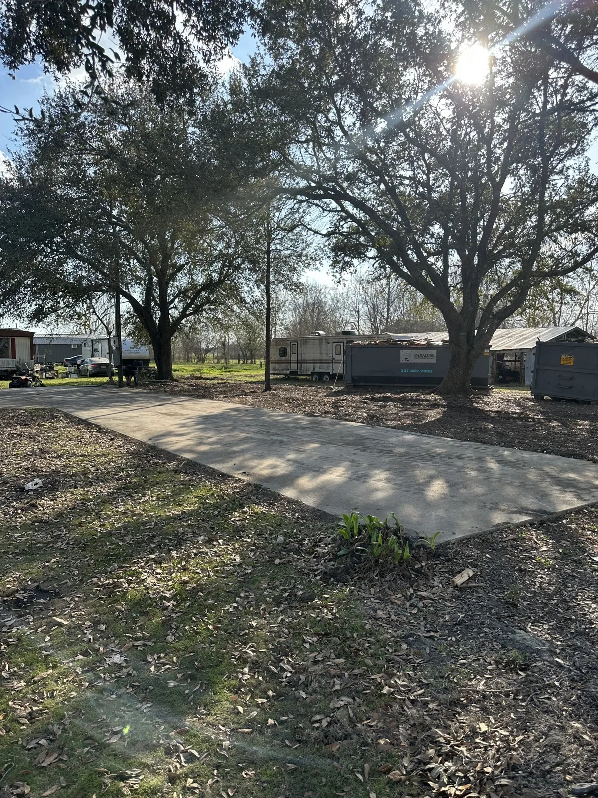 Site cleaned to the slab with debris loaded out in a roll-off container